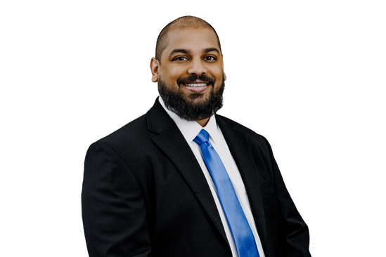 Man in business suit smiling for professional headshot.